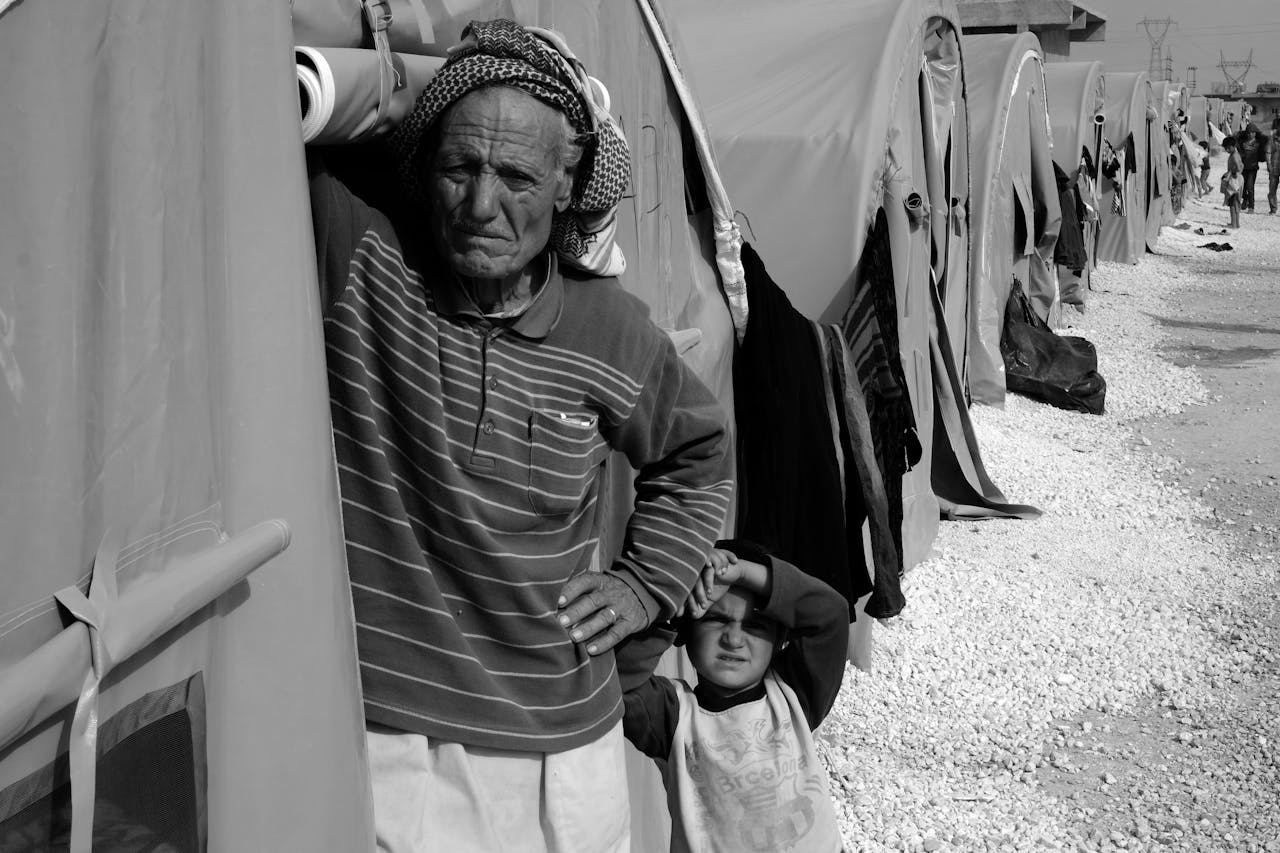 services-03 Black and white image of refugees in a camp, highlighting humanity and resilience.